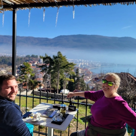       People enjoying a scenic view from a terrace.
  