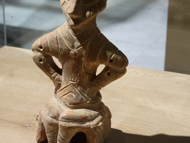       Small ancient artifact on display.
  