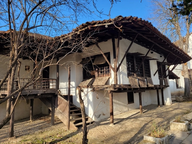       Traditional wooden house with a porch.
  