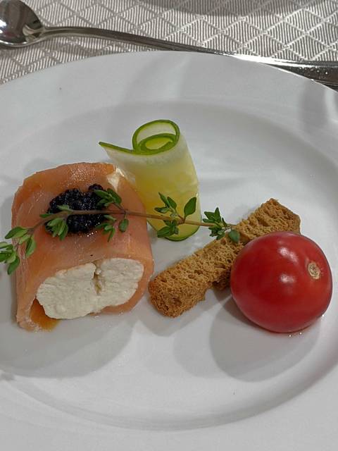       Gourmet dish featuring smoked salmon, caviar, and vegetables on a white plate.
  