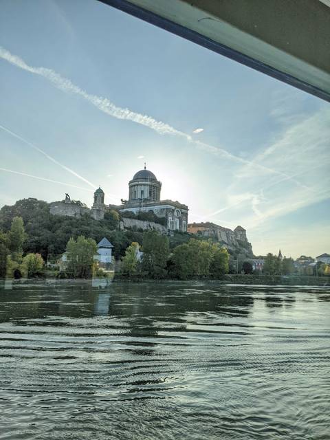       Esztergom Basilica on a hill under a blue sky.
  
