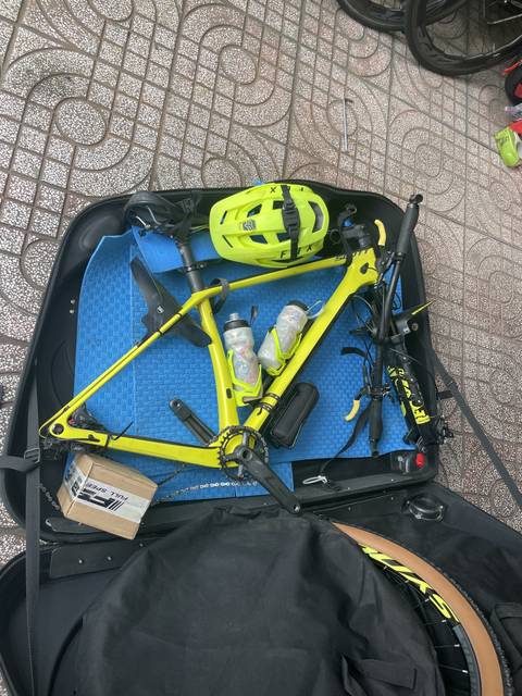       Bicycle parts and helmet on a mat.
  