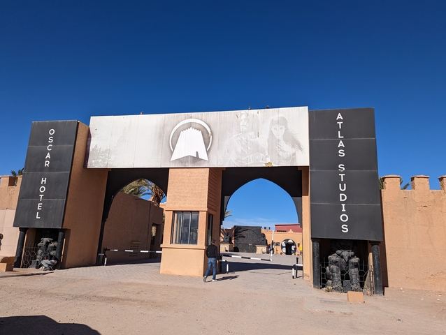       Entrance to Oscar Hotel Atlas Studios with large decorative gates and murals.
  