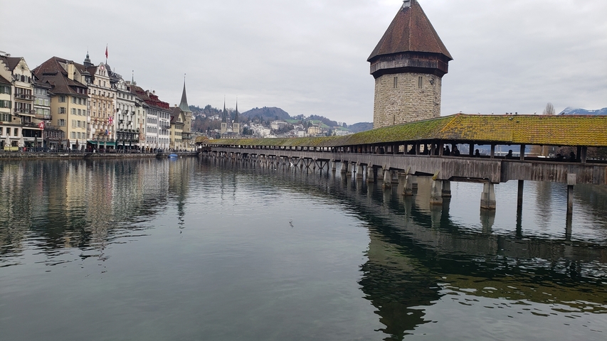 Historic bridge over a river with traditional buildings.