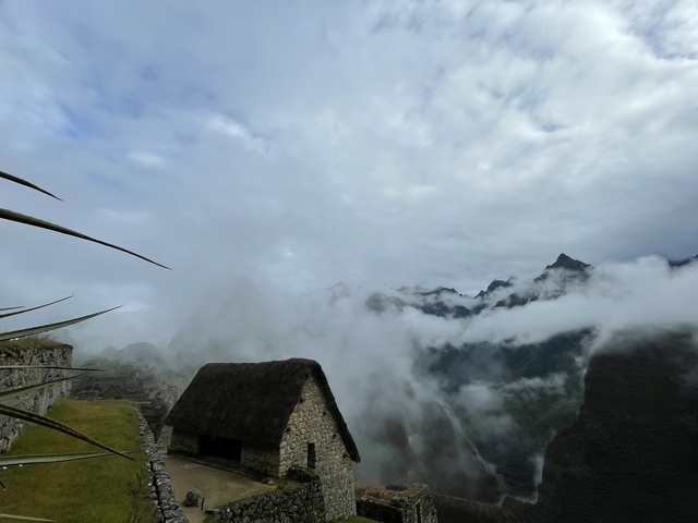 Foggy view of Machu Picchu with mountains in the background