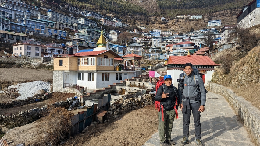Two people posing in a mountainous town