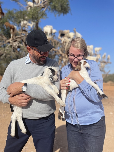 Couple holding baby goats