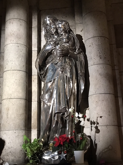       Statue of a religious figure holding a child.
  