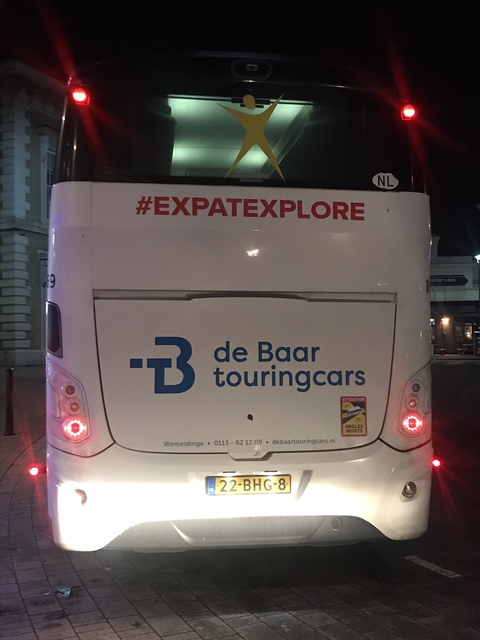       Back of a tour bus with company logos.
  