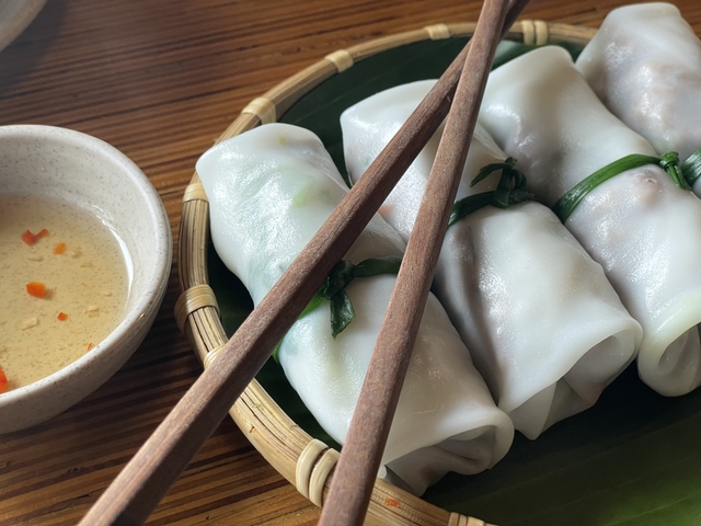       Vietnamese spring rolls with sauce and chopsticks.
  
