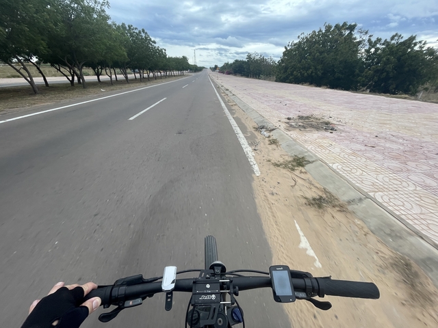       Aerial view of a bicycle on an empty road.
  