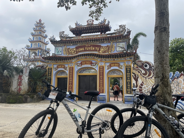       Colorful temple entrance with bicycles in front.
  