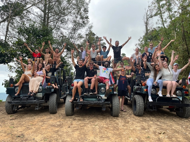 Large group of people cheering and posing on a jeep safari.