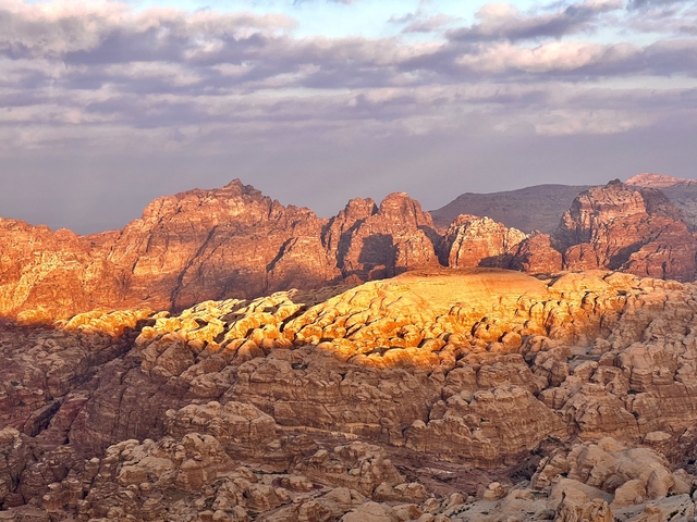       Dramatic mountain range with glowing sunlight.
  