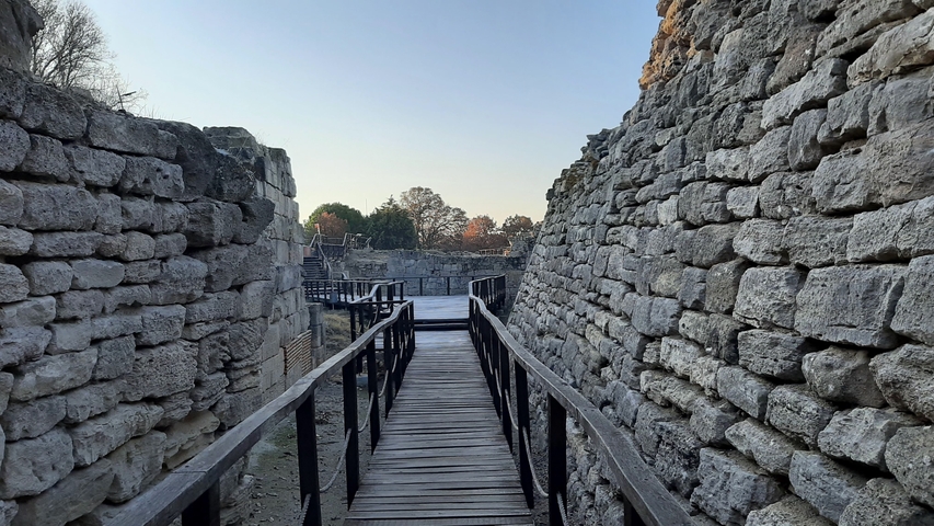       Ancient stone brick pathway through ruins, viewed from a high angle.
  