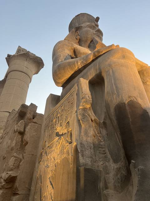       Ancient stone statue with hieroglyphics.
  