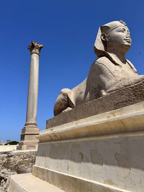 Large stone statue with a column.