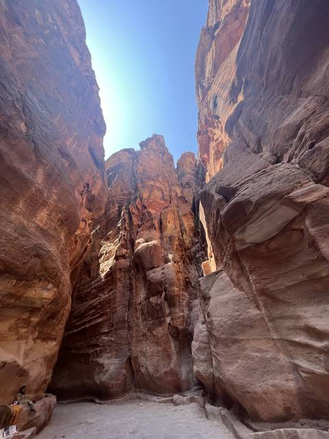 Narrow canyon path between towering rock walls.