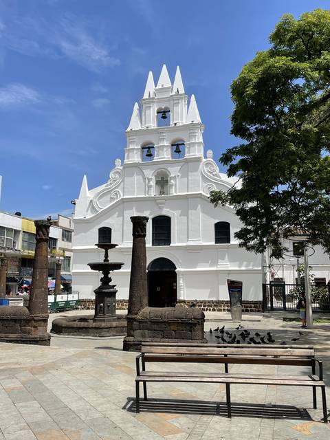       White church with blue sky background
  
