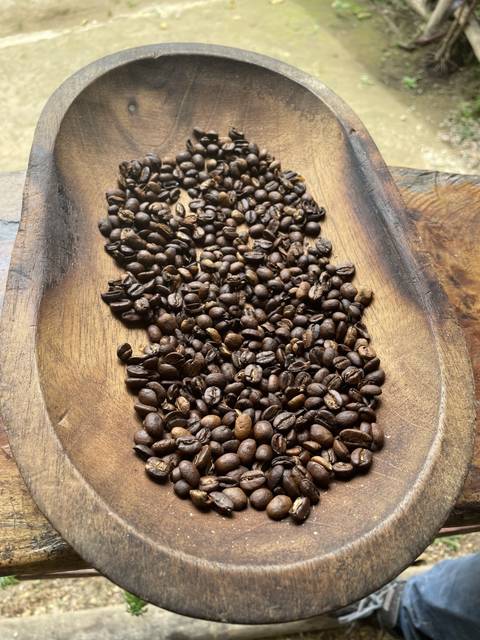       Roasted coffee beans on a wooden tray
  