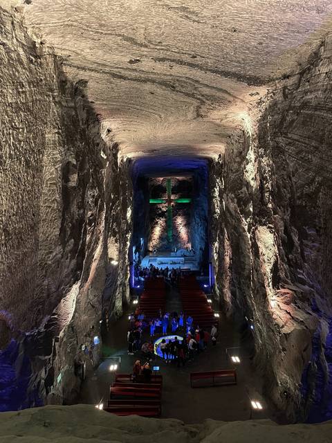       Interior of a chapel with illuminated cross
  