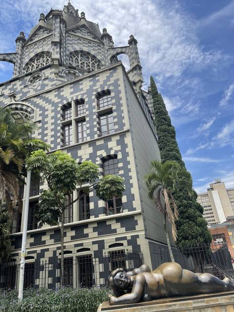       Sculpture garden with checkered building
  