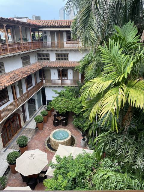       Spanish colonial courtyard with palm trees
  