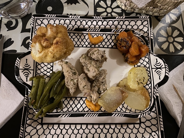       Plate of traditional dish with sides.
  