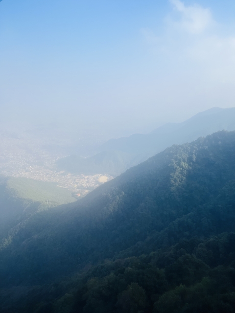      Hazy and foggy view from a mountain landscape.
  