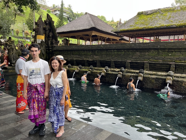       Group of people at a water purification site in traditional attire.
  