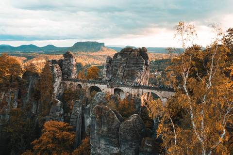 Bastei Bridge amidst autumn foliage.