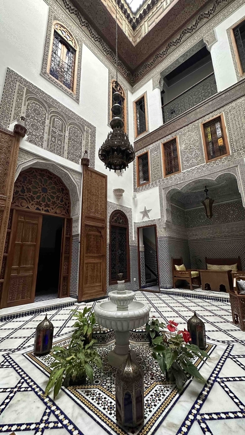 Intricate indoor architecture with mosaics and archways.