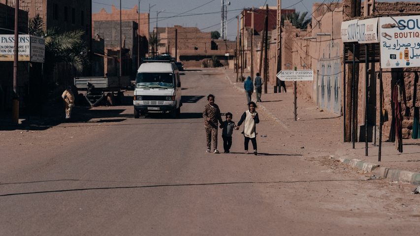 Street view with three children holding hands