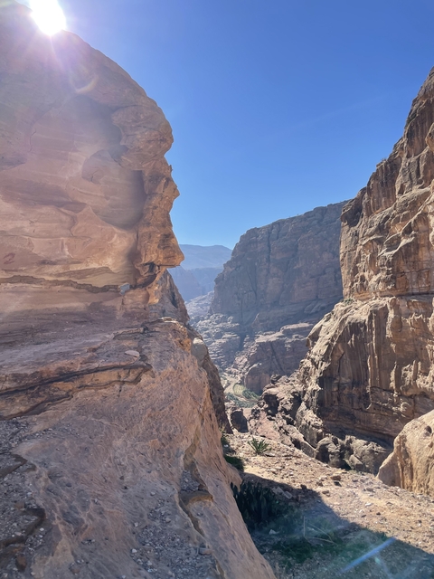 Rocky canyon with sunlight illuminating the cliffs.