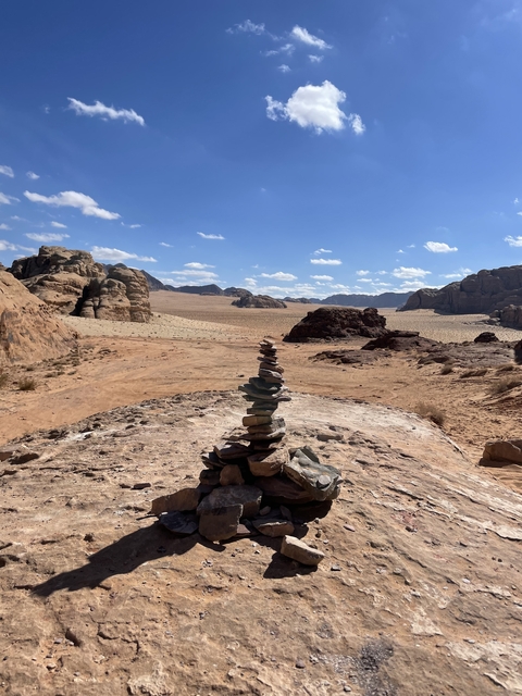 Cairn of stones in a desert landscape.