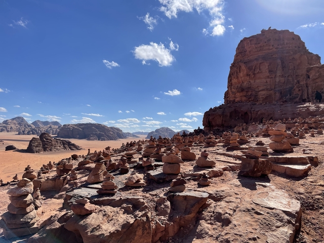       Rock formations and stone carvings in a desert landscape.
  