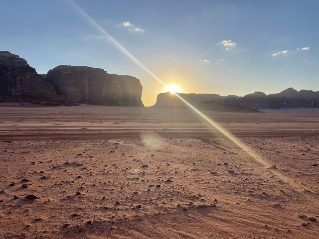       Sunset over a desert with dramatic lighting.
  