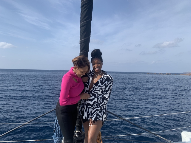 Two people on a boat enjoying the sea view.