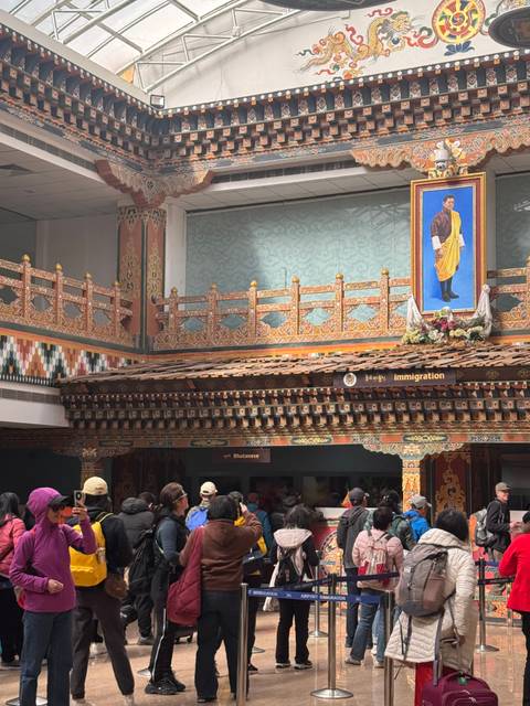 Decorative building interior with people standing in line.