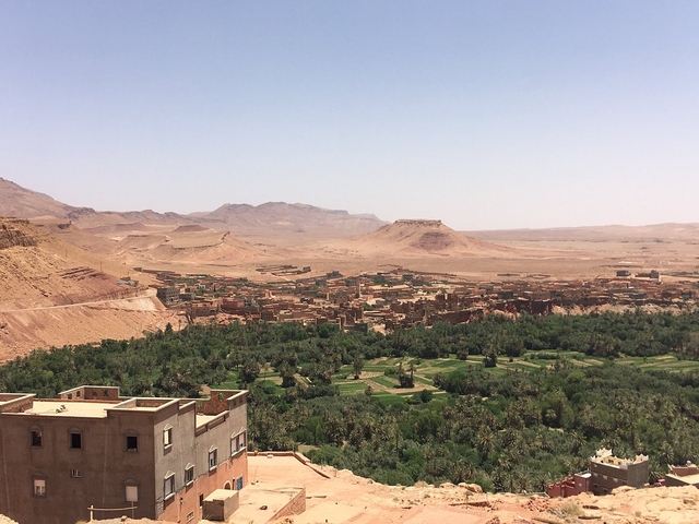       Distant view of a vast landscape with fields and mountains.
  