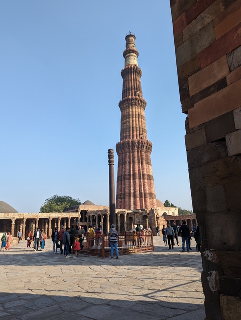 Qutub Minar in Delhi with blue sky.