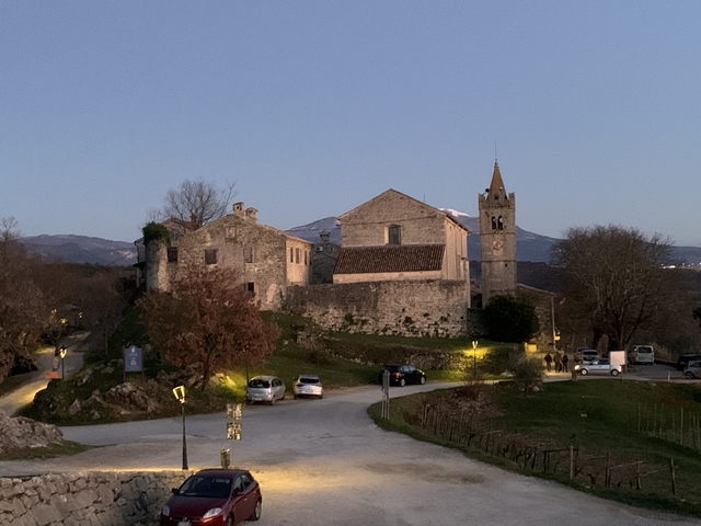       Stone structure with a bell tower at dusk.
  