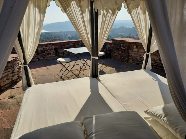       Luxurious outdoor patio seating with a scenic view.
  