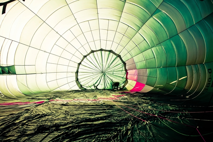Inside a hot air balloon being inflated, with a person visible.
