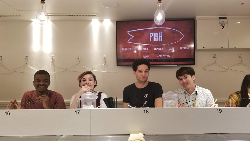 People sitting at a bar with a fish theme.