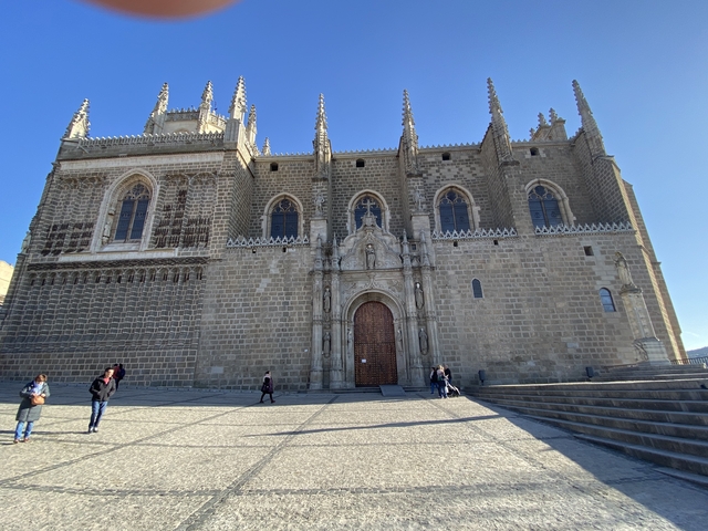 Gothic cathedral with people walking in front.