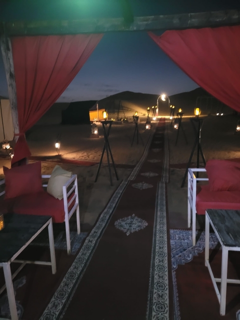 Desert camp setup with ambient lighting at night.