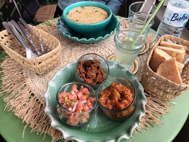 Assortment of dishes including bread and condiments on a table.
