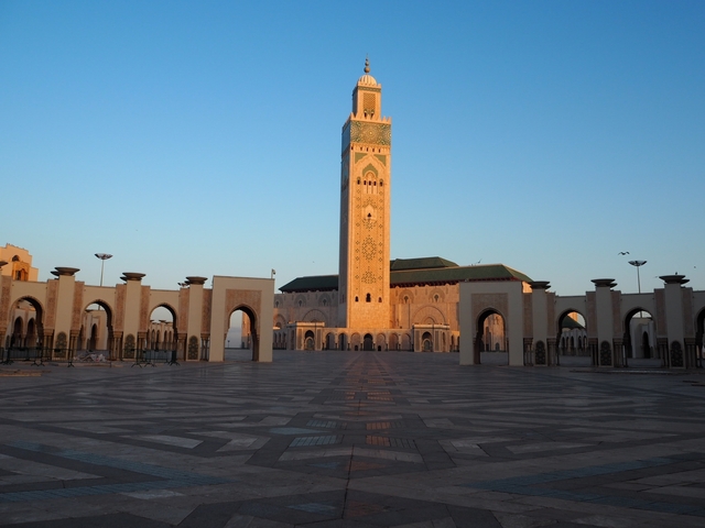 Hassan II Mosque in Casablanca with arches in the foreground.