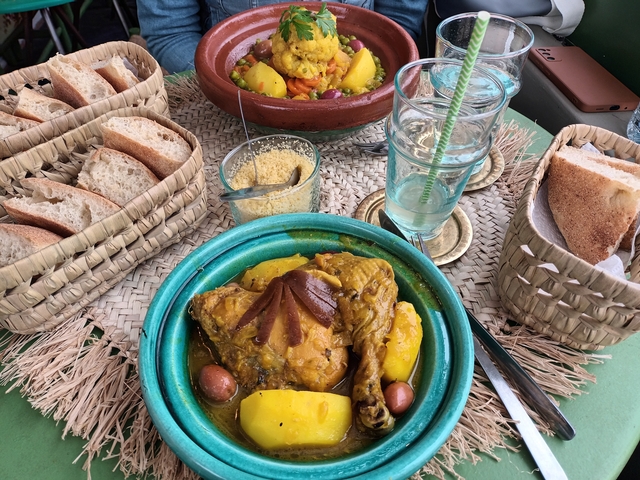 Close-up of traditional Moroccan dishes including bread, soup, and tagine.